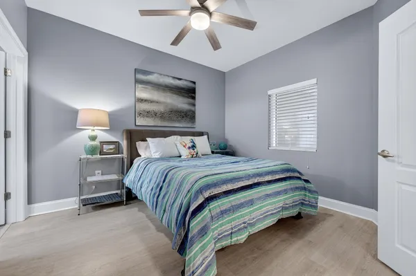 a bedroom with a bed and a chandelier