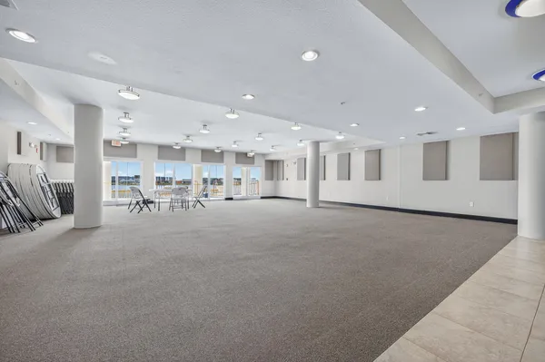 a large kitchen with stainless steel appliances kitchen island granite countertop a refrigerator and a sink