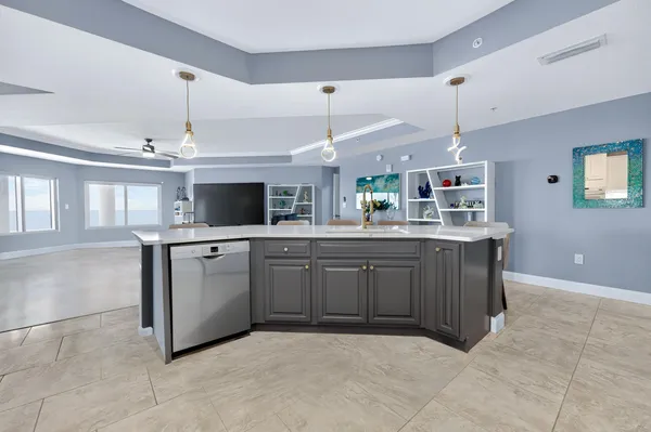 a kitchen with kitchen island granite countertop a sink counter top space appliances and a window