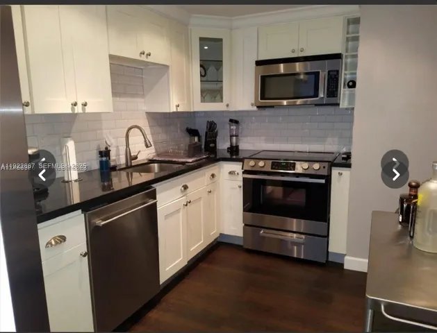 a kitchen with a sink stove and microwave
