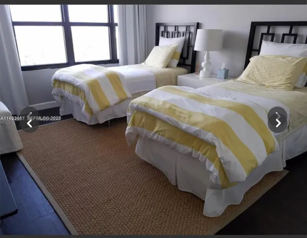 a bedroom with two beds and a window