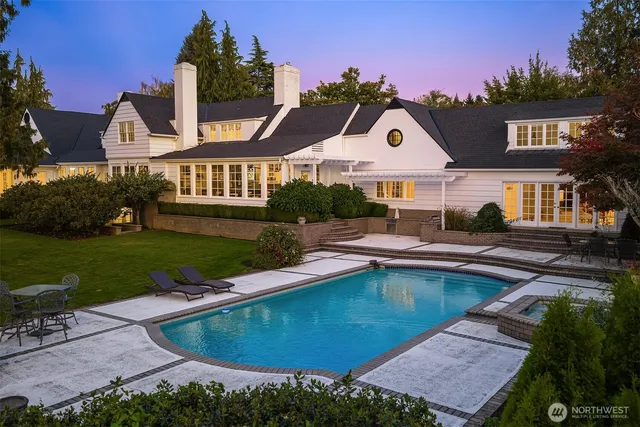 a view of a house with swimming pool and yard