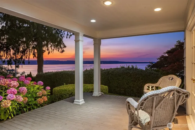 a front view of a house with a garden and balcony