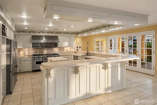 a kitchen with stainless steel appliances kitchen island granite countertop a sink and cabinets