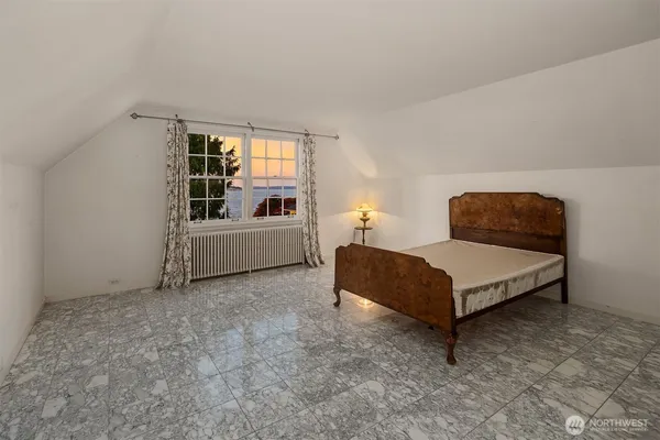 a bedroom with a bed and window