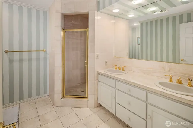a bathroom with a double vanity sink and a mirror