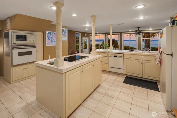 a kitchen with appliances cabinets and furniture