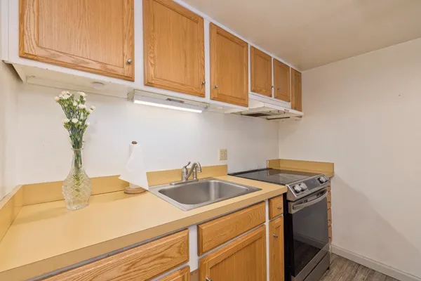 a kitchen with stainless steel appliances granite countertop a sink and a white cabinets