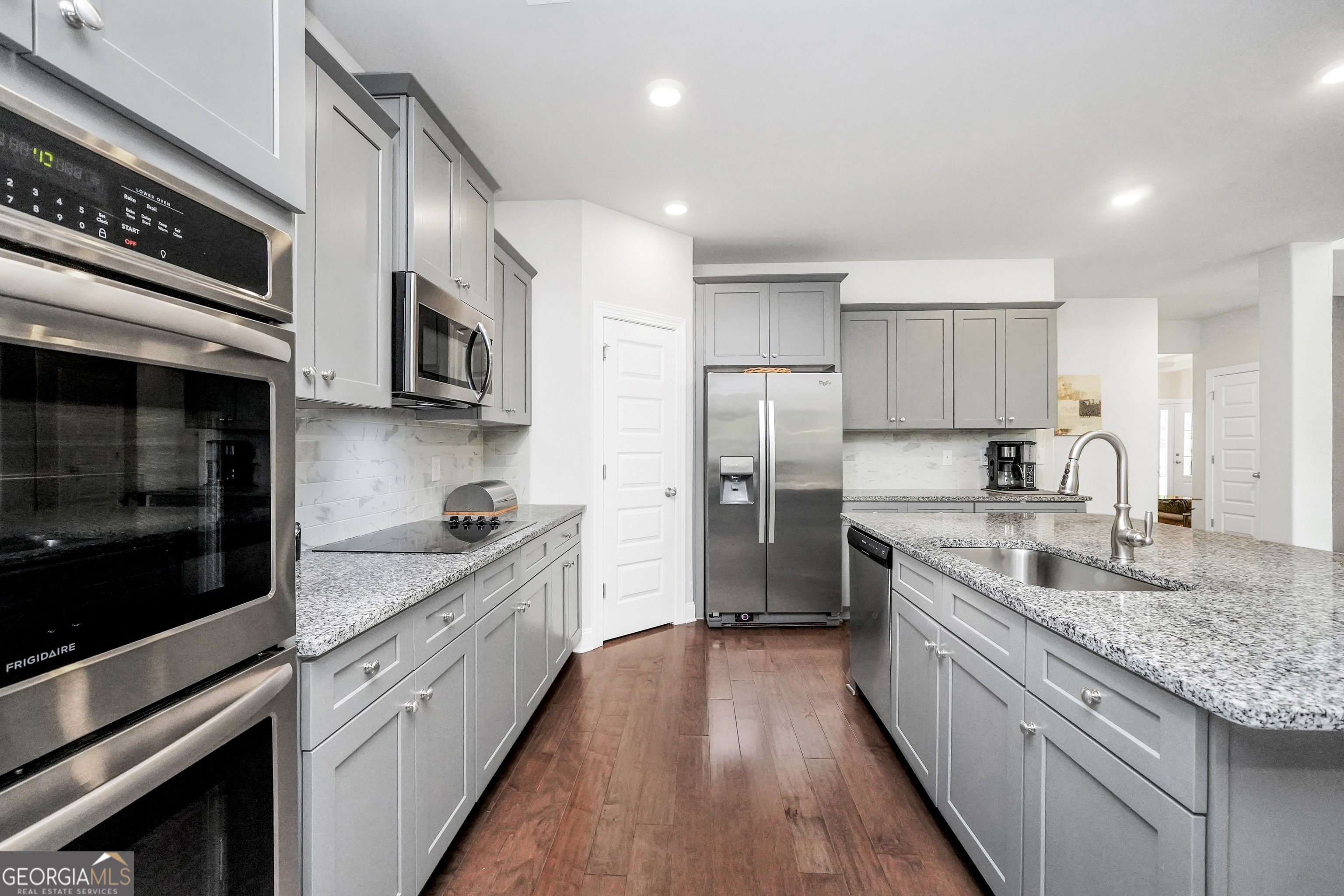 800 Rock House Road Senoia, GA 30276 - Photo 5 of 23 a large kitchen with stainless steel appliances granite countertop a lot of counter space and wooden floor