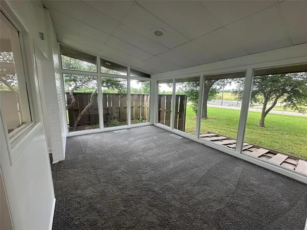 a view of an empty room with a large window