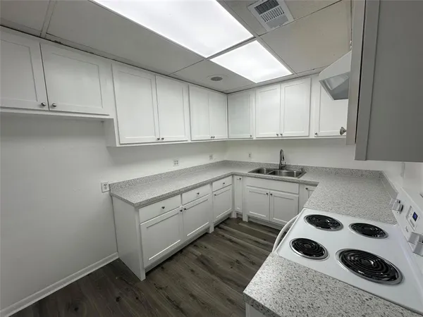 a kitchen with a cabinets and white appliances