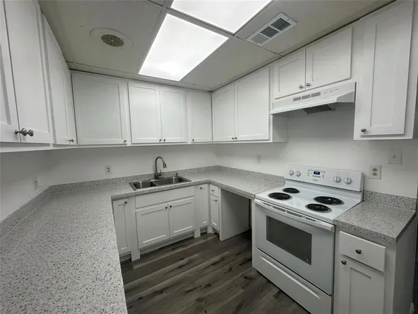 a kitchen with granite countertop cabinets stainless steel appliances and sink