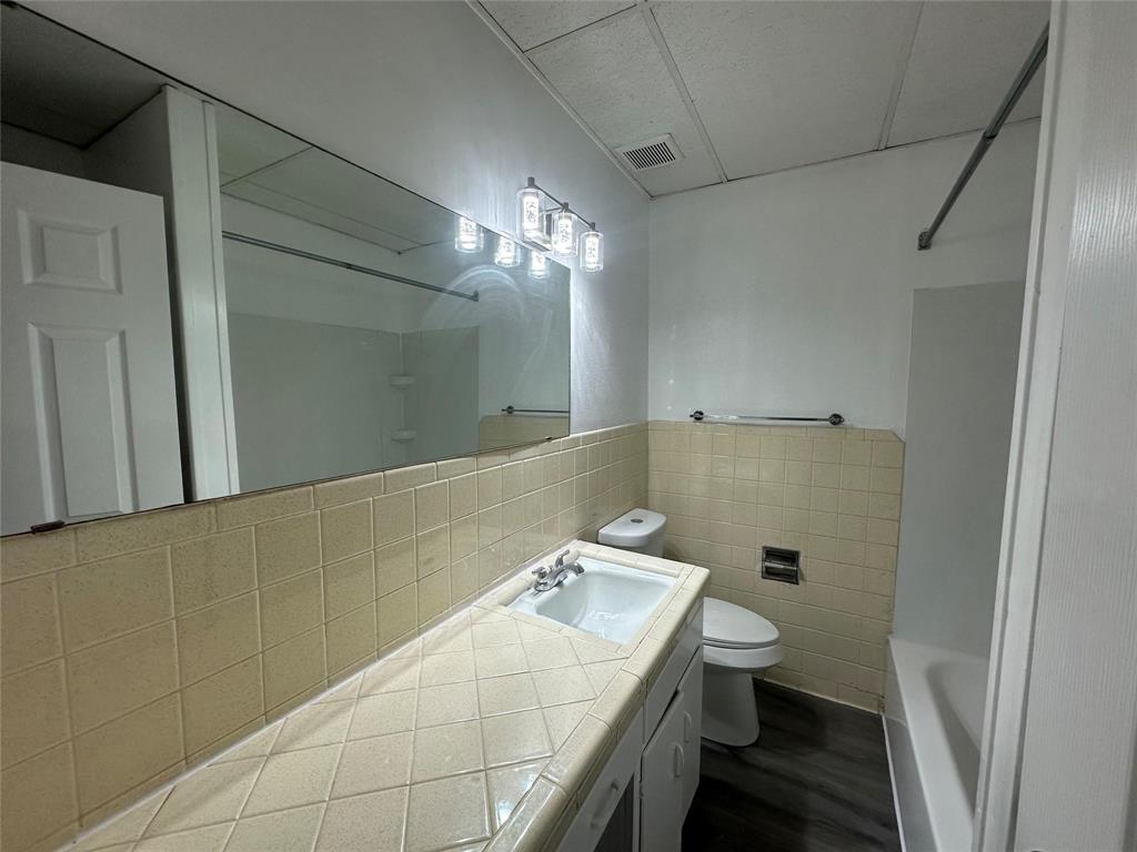 4723 North Loy Lake Road Sherman, TX 75092 - Photo 8 of 16 a bathroom with a sink a toilet and shower