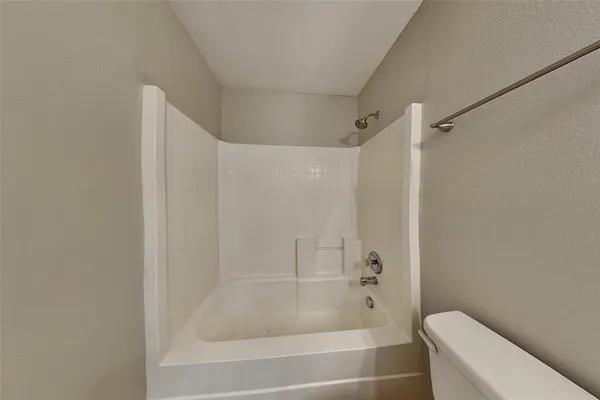 a bathroom with a bathtub and a toilet
