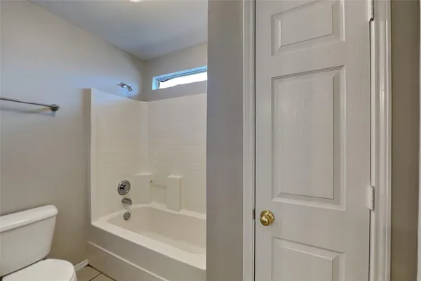 a bathroom with a toilet and a bathtub