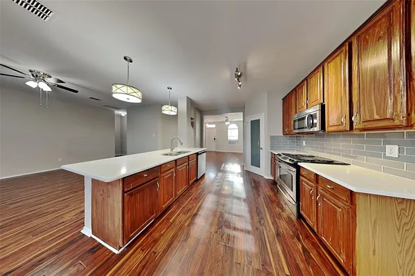 a kitchen with stainless steel appliances granite countertop a stove and a sink
