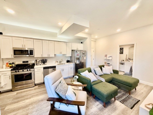5 Fremont Street, Unit 301 Winthrop, MA 02152 - Photo 4 of 18 a living room with furniture white cabinets and stainless steel appliances