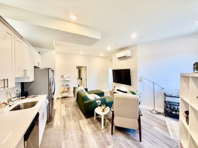 5 Fremont Street, Unit 301 Winthrop, MA 02152 - Photo 6 of 18 a living room with furniture and a flat screen tv