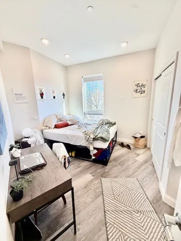 a bedroom with furniture and a wooden floor