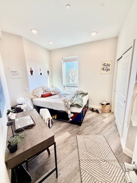 5 Fremont Street, Unit 301 Winthrop, MA 02152 - Photo 7 of 18 a bedroom with furniture and a wooden floor