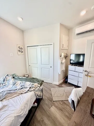 a bedroom with a bed and a flat screen tv
