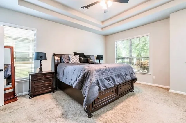 a bed sitting in a room next to a window