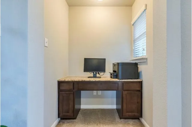 a view of a workspace with furniture
