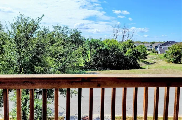 a view of a balcony with wooden fence