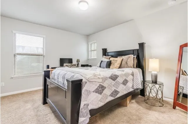 a bedroom with a bed and a window