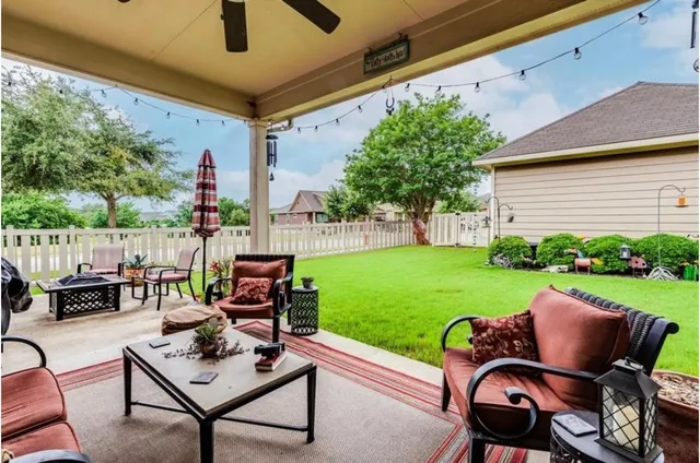 a view of a patio with chair and tables