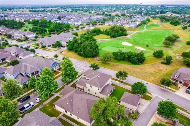 an aerial view of residential houses with outdoor space
