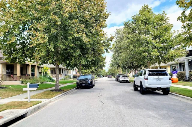 a view of the street with parked cars