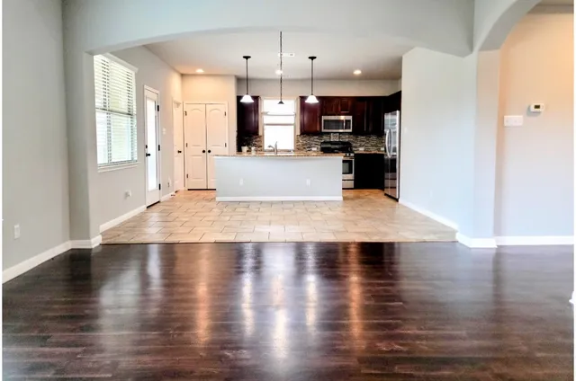 a view of a kitchen with wooden floor