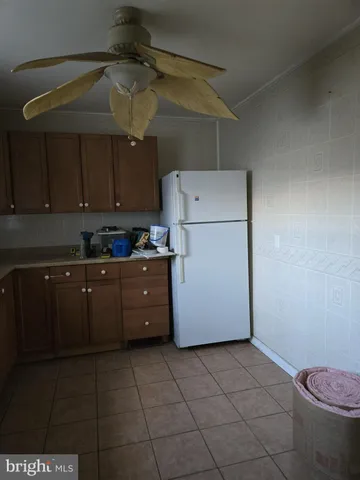 a kitchen with a refrigerator a stove a sink and cabinets