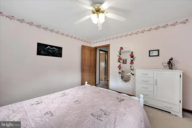 a view of livingroom with hardwood floor and a ceiling fan