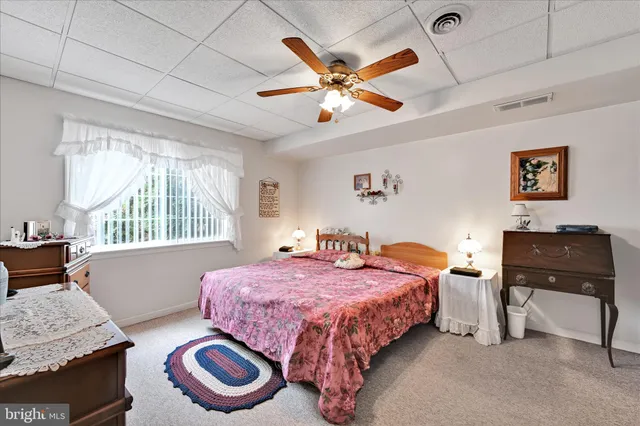 a living room with furniture a chandelier furniture and a window