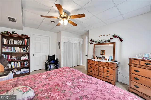 a room with a book shelf a book shelf and a couch