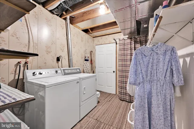 a view of backyard of house with outdoor seating and green space