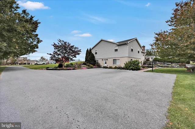 a view of a house with backyard and sitting area