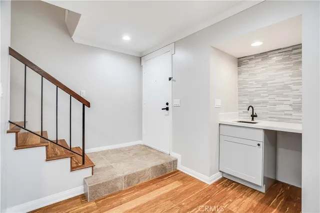 a view of entryway and hall with wooden floor