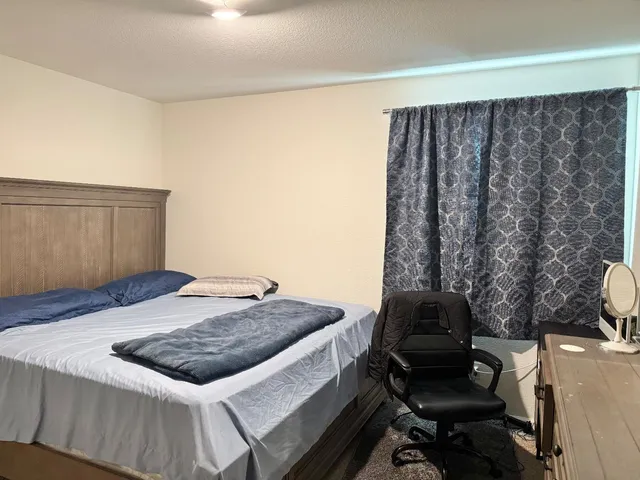 a bedroom with a bed and a dresser