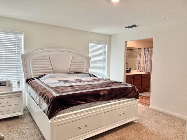 a bathroom with a double vanity sink mirror and shower