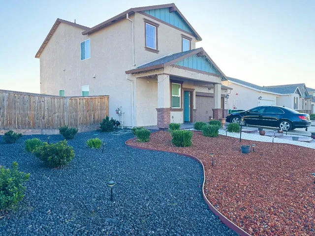 a front view of a house with garden