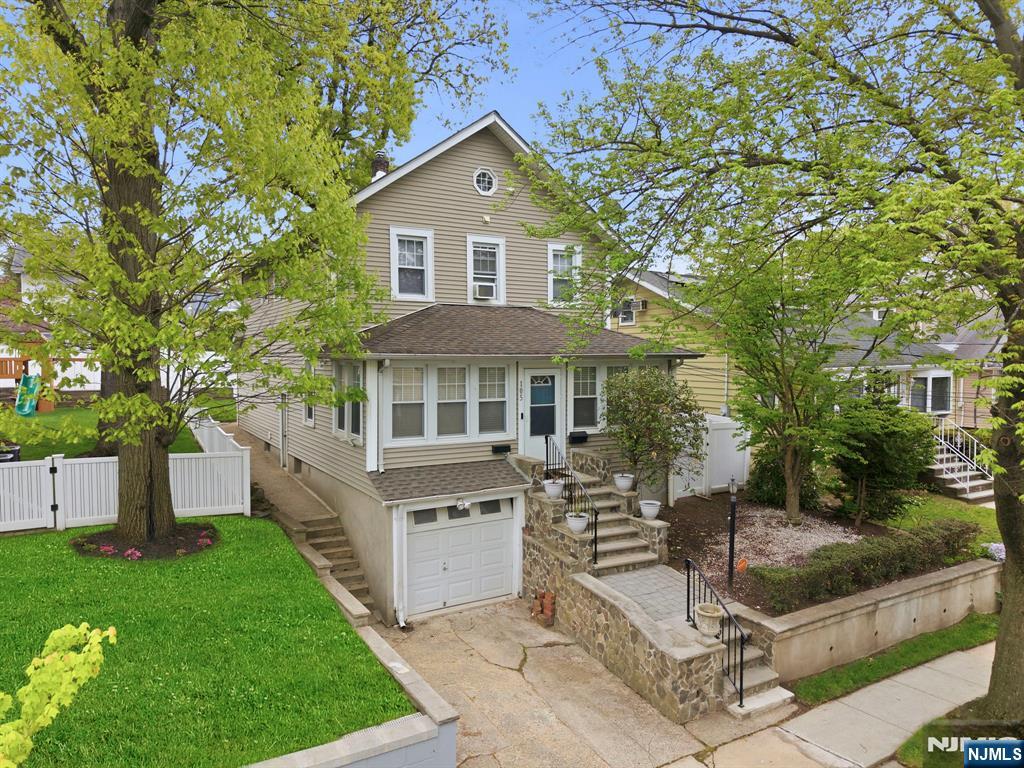 105 Daniel Avenue Rutherford, NJ 07070 - Photo 1 of 38 a front view of a house with a garden