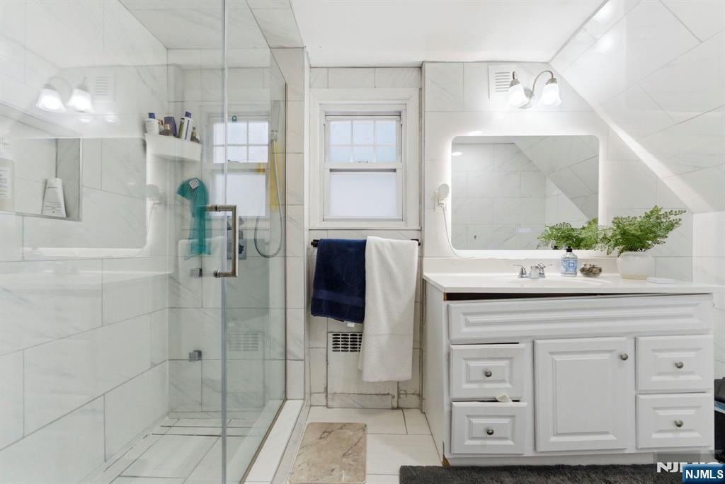 105 Daniel Avenue Rutherford, NJ 07070 - Photo 17 of 38 a bathroom with a sink and a mirror