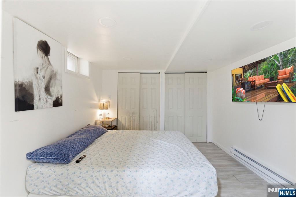 105 Daniel Avenue Rutherford, NJ 07070 - Photo 24 of 38 a bedroom with a bed and a painting on the wall