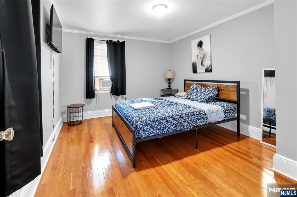 105 Daniel Avenue Rutherford, NJ 07070 - Photo 32 of 38 a bedroom with a bed and wooden floor