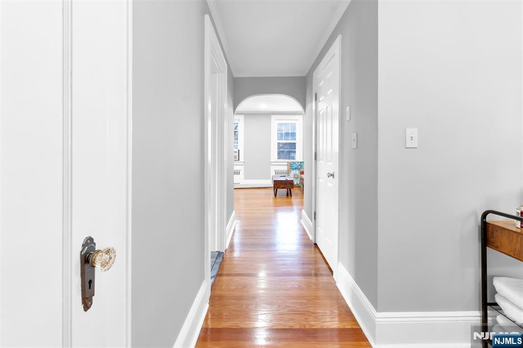105 Daniel Avenue Rutherford, NJ 07070 - Photo 33 of 38 a view of a hallway with wooden floor and a living room