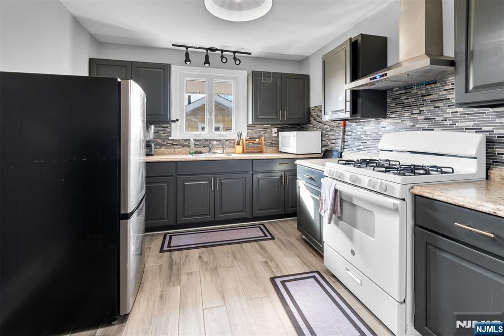 105 Daniel Avenue Rutherford, NJ 07070 - Photo 35 of 38 a kitchen with stainless steel appliances granite countertop a stove a sink and a refrigerator