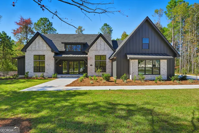 a front view of a house with a yard and porch